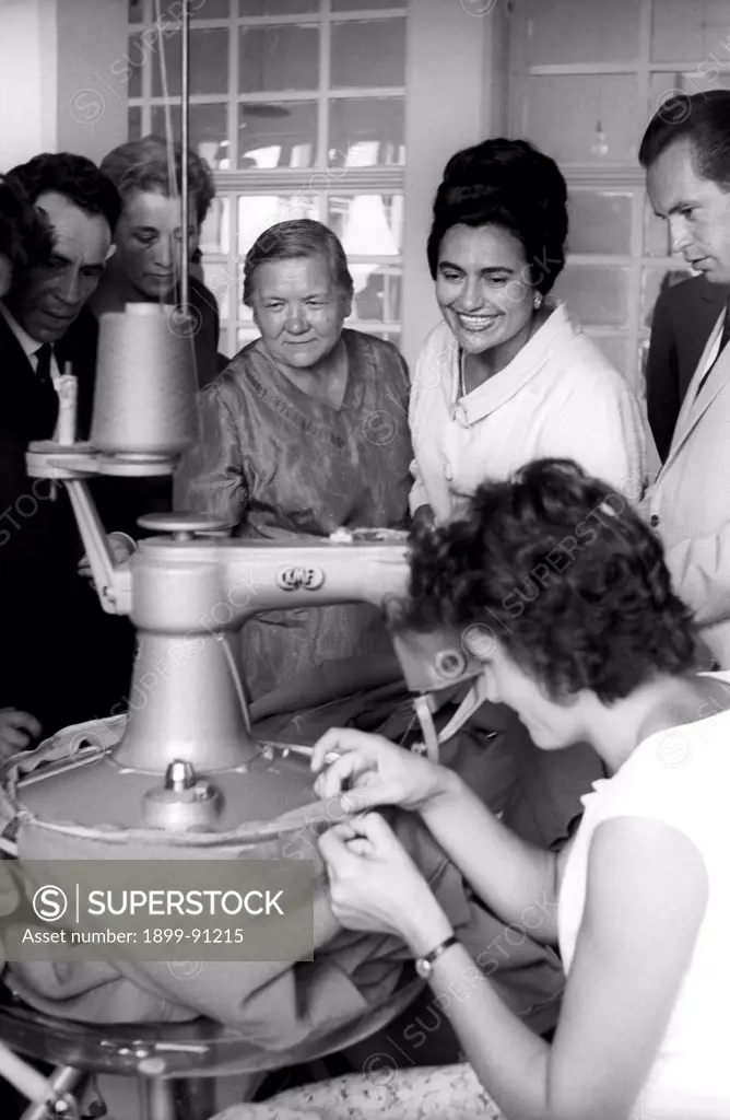 The Yugoslavia First Lady, Jovanka Broz (the Yugoslav leader Tito's fourth wife since 1952), and Nina Khrushchev, the Soviet leader Nikita Khrushchev's wife, are watching a manufacturing phase of a clothing in a Yugoslav industrial company. Beograd (Yugoslavia, now Serbia), 1963.