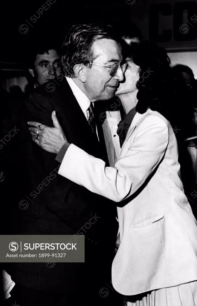 Italian journalist and member of the Parliament Giulio Andreotti getting a kiss from a member of his party during the National Friendship Day organized by the Christian Democratic Party (DC). Trento, 1981