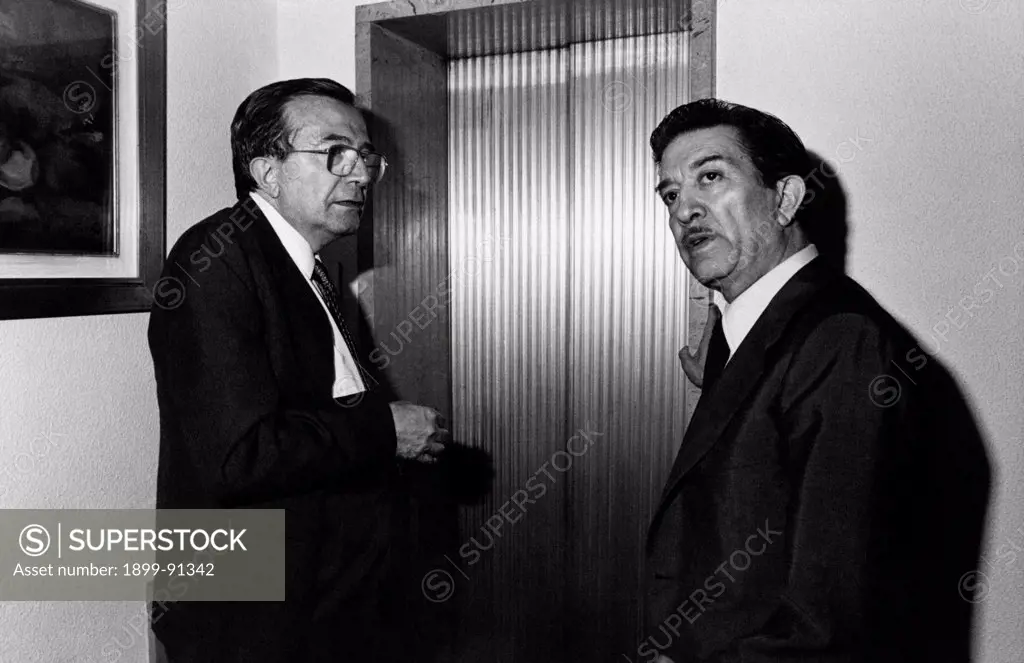 Italian journalist and member of the Parliament Giulio Andreotti standing  with Italian politician Franco Evangelisti during the National Friendship Day organized by the Christian Democratic Party (DC). Trento, 1981