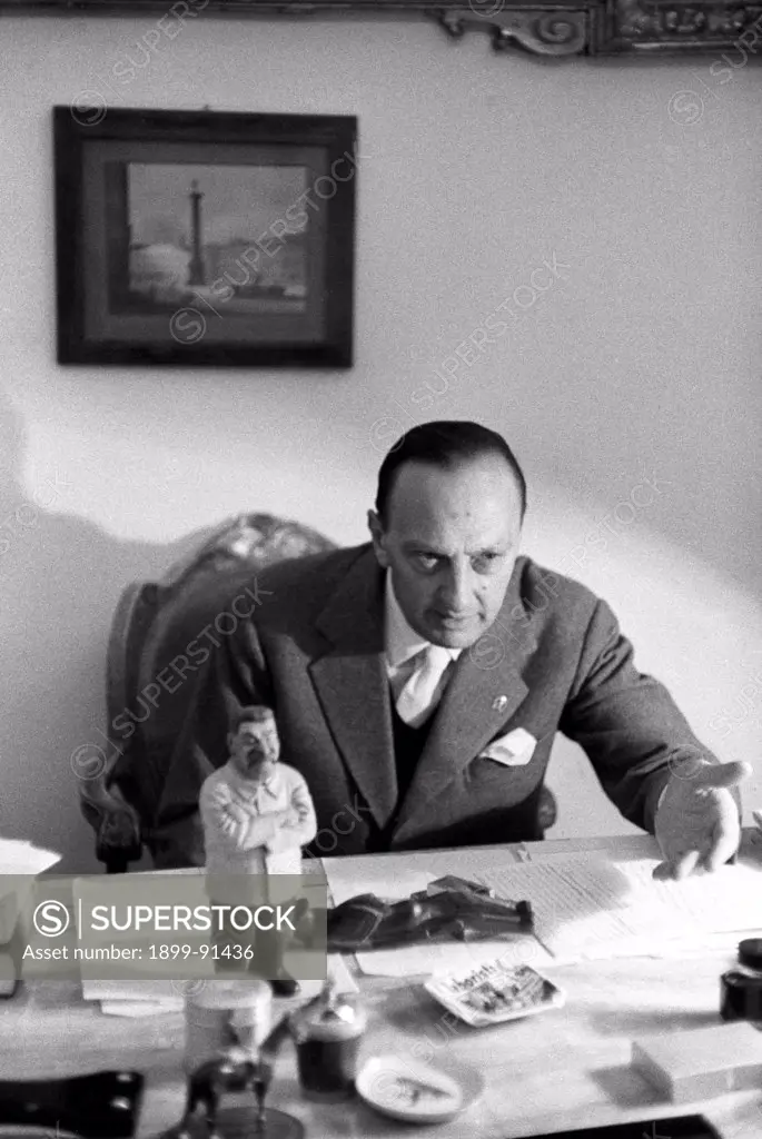 Portrait of Italian senator and founder and director of daily newspaper Il Tempo Renato Angiolillo. On his desk one can see a caricatural figure of   Stalin (Iosif Vissarionovic). Rome, 1st December 1956