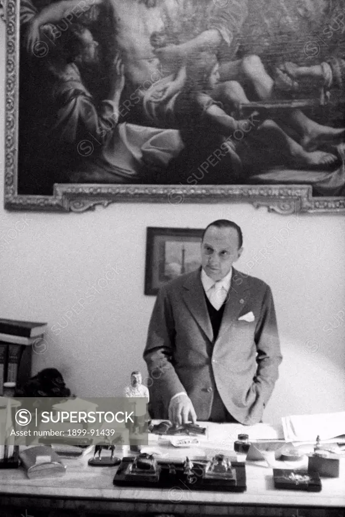 Portrait of Italian senator and founder and director of daily newspaper Il Tempo Renato Angiolillo. On his desk one can see a caricatural figure of   Stalin (Iosif Vissarionovic). Rome, 1st December 1956