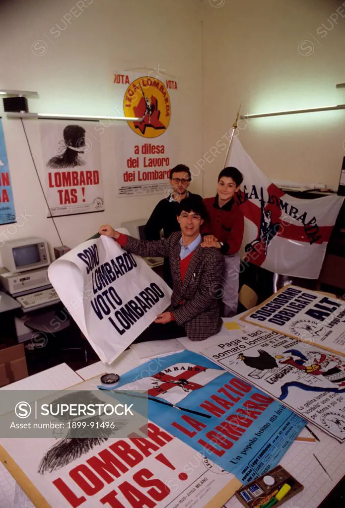 Italian politician Umberto Bossi showing a poster of the Lombard League. 1980s