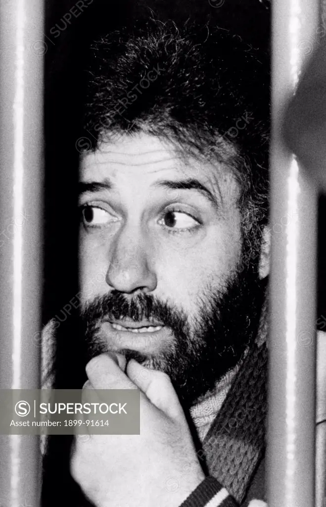 Italian terrorist Renato Curcio, founder and ideologist of the left-wing terrorist group Red Brigades, touching his chin behind bars during the trial against forty-six members of the group. Renato Curcio is charged with organization of an armed group targeting the violent suppressing of legal, economic and political systems of Italian State. Turin, March 1978