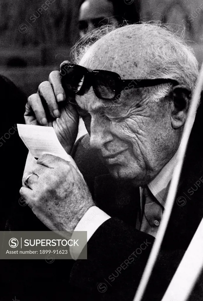 Italian socialist deputy Pietro Nenni reading with difficulty a piece of paper lifting his eyeglasses. 7th March 1976