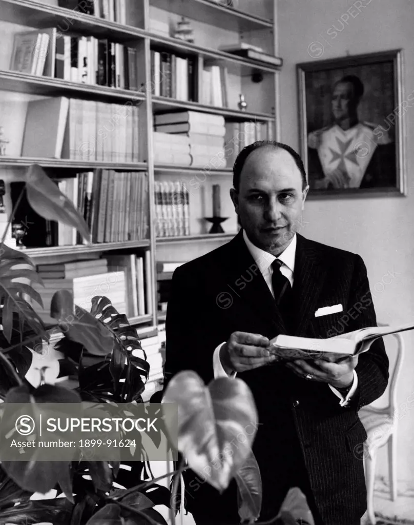 Italian lawyer and Christian Democrat deputy Danilo De' Cocci holding an open book. 1963