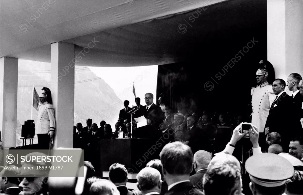 The President of the Italian Republic Giuseppe Saragat giving a speech for the inauguration of the Mont Blanc Tunnel. The President of the French Republic Charles de Gaulle listening to him. July 1965