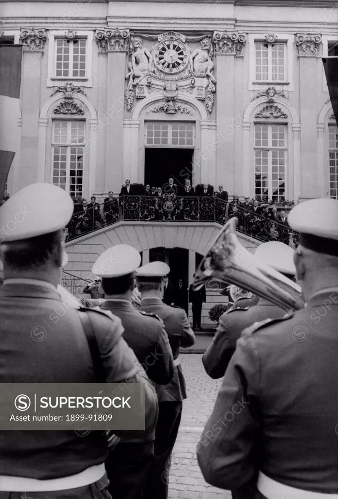 The band welcoming the President of the Italian Republic Giuseppe Saragatduring a diplomatic journey. Behind him, a clock with two sculptures depicting two Satyrs. Germany, July 1965