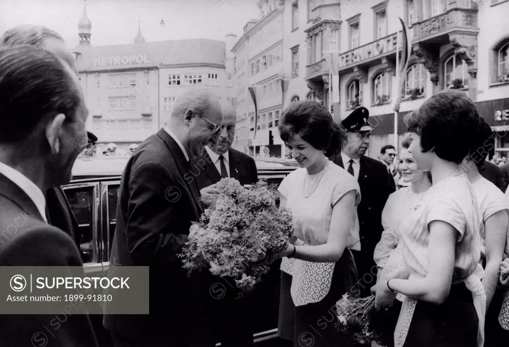 A girl giving a bunch of flowers to the President of the Italian Republic Giuseppe Saragat. Germany, July 1965