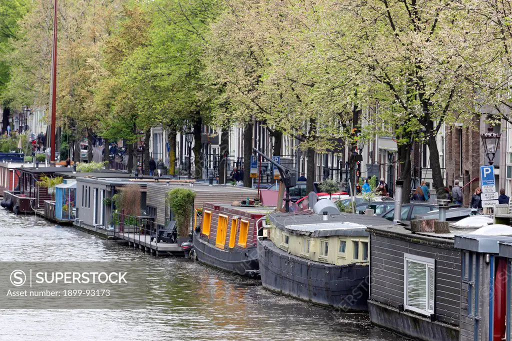 Amsterdam, Netherlands, Holland, Europe, small boats houseboats on canal by the Noordermarkt.