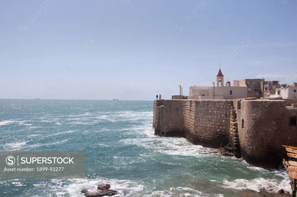 Historic seawall, fortress, and the 1737 Franciscan Church of St. John bell tower on the southern side of the Old City in Acre, Israel. (Photo by: Independent Picture Service/UIG via Getty Images)