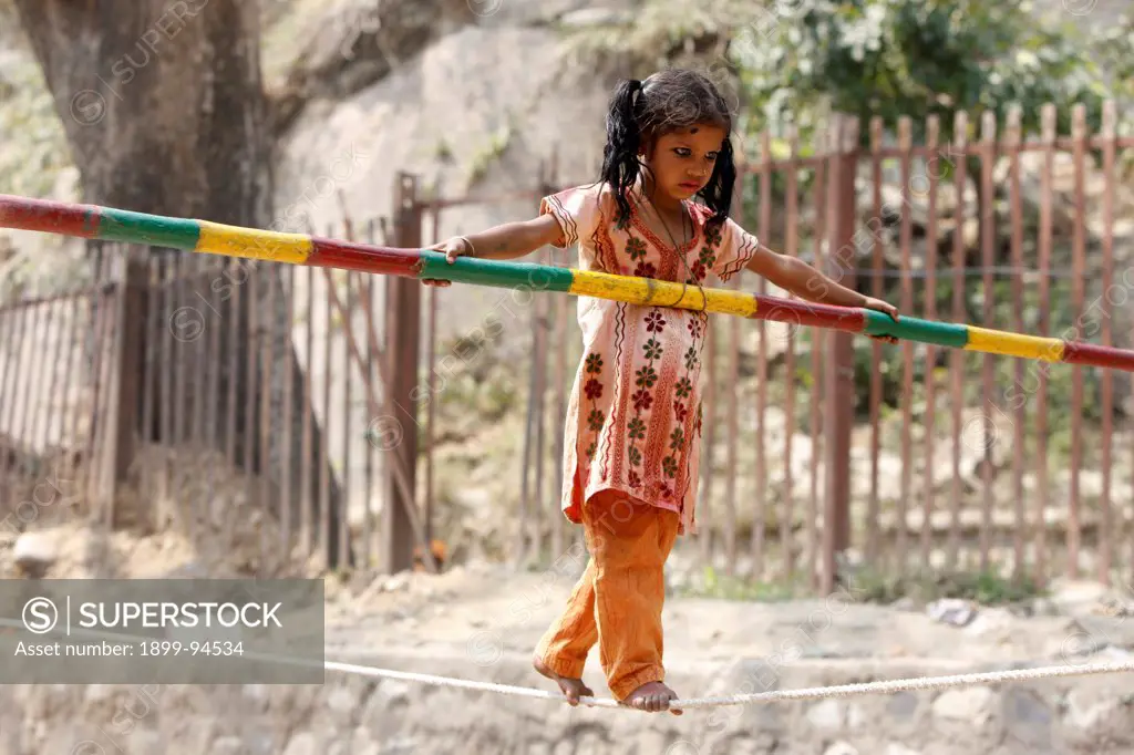 Child worker , tightrope walker, Haridwar, India.,03/18/2010