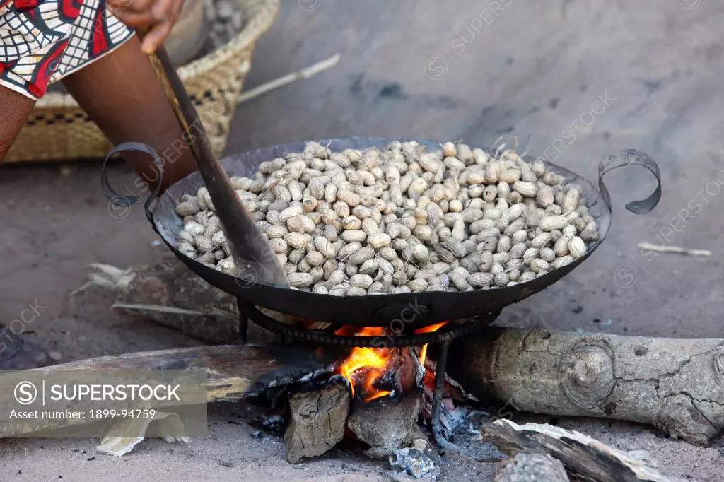 Woman roasting peanuts, Abene, Senegal.,12/14/2008