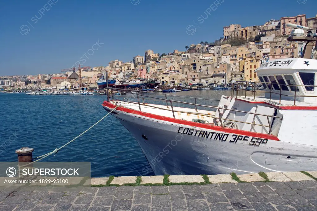 Fishing boats in harbor town in background Sciacca Sicily Italy Europe.  03/06/2009