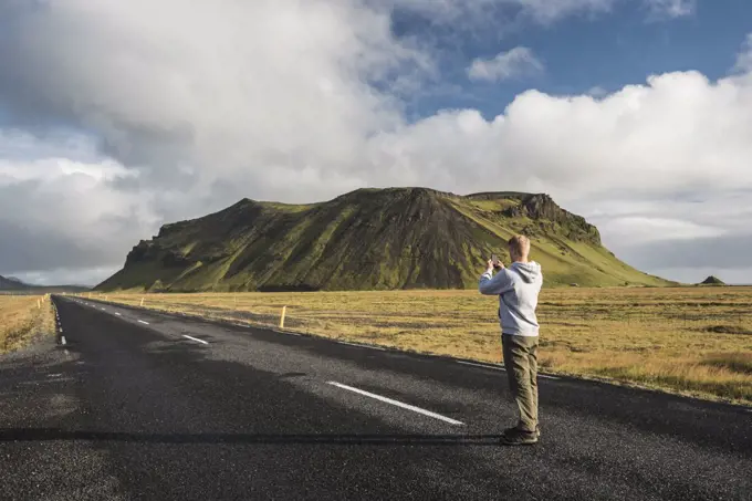 Tourist taking a photo from route 1 near Vik, South Region, Sudurland, Europe