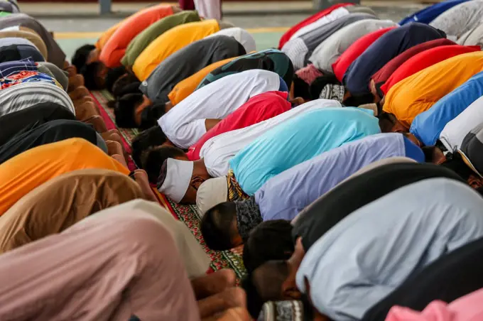 Filipino Muslims wearing protective masks as a precaution against the coronavirus outbreak gather as they attend a midday prayer in observance of Ramadan inside a Muslim community in Marikina city, Philippines.