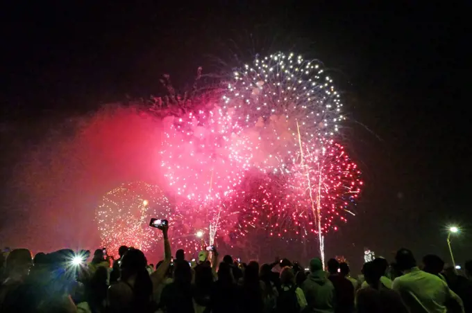 Crowds watching Macy's Fourth of July fireworks display, Manhattan.