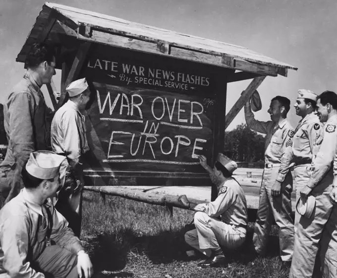 An Army private is shown breaking the news of the end of the war in Europe to other Soldiers after receiving an Associated Press news flash - circa May 8, 1945.