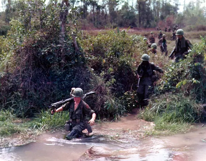 The Second Indochina War, known in America as the Vietnam War, was a Cold War era military conflict that occurred in Vietnam, Laos, and Cambodia from 1 November 1955 to the fall of Saigon on 30 April 1975. This war followed the First Indochina War and was fought between North Vietnam, supported by its communist allies, and the government of South Vietnam, supported by the U. S. and other anti-communist nations. The U. S. government viewed involvement in the war as a way to prevent a communist takeover of South Vietnam and part of their wider strategy of containment. The North Vietnamese government viewed the war as a colonial war, fought initially against France, backed by the U. S. , and later against South Vietnam, which it regarded as a U. S. puppet state. U. S. military advisors arrived beginning in 1950. U. S. involvement escalated in the early 1960s, with U. S. troop levels tripling in 1961 and tripling again in 1962. U. S. combat units were deployed beginning in 1965. Operations