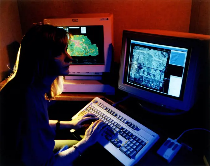 September 1996 - Scientist at computer analyzing multiple layers of data. 
