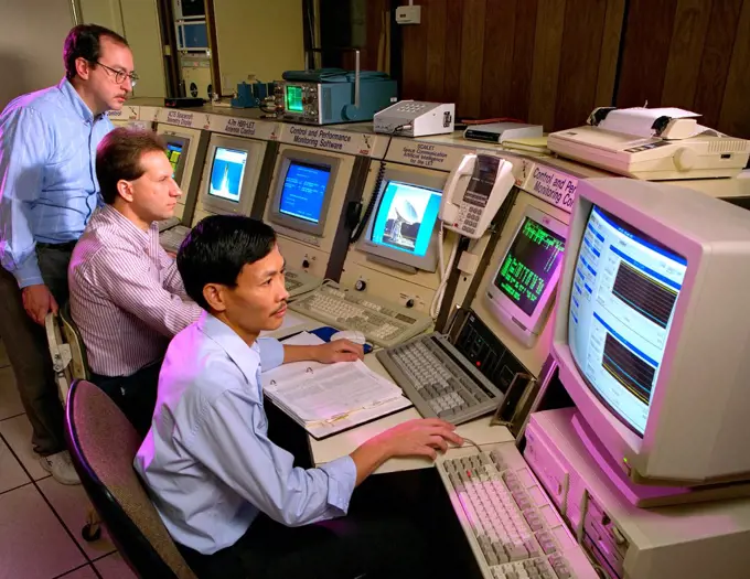 Workers at NASA's Lewis Research Center - viewing information on computer monitors in 1996. 