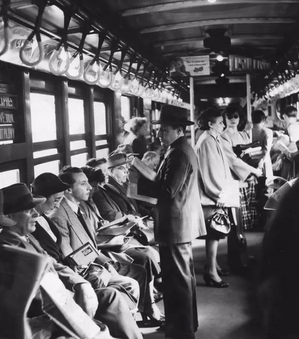 New York subway trains sometimes emerge from the darkness of the tunnels into the open air. This picture, made on an elevated section of track, shows riders during a non-rush hour period reading books and newspapers, or waiting patiently for their stops, New York, NY, 1948. (Photo by United States Information Agency/GG Vintage Images)