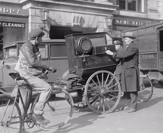 Street scene: bike, man with cart near laundry ca. between 1909 and 1932.