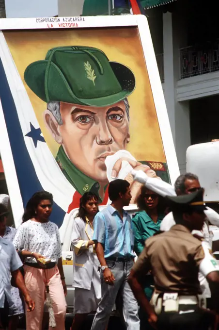 Panamanian civilians carry a portrait of former President Omar Torrijos through the streets outside the gate of Fort Amador, headquarters of the US Southern Command. 