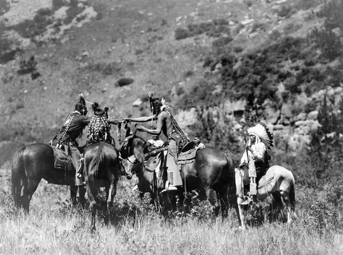 Edward S. Curtis Native American Indians -  Crow men on horseback apparently involved in an exchange ca. 1905. 