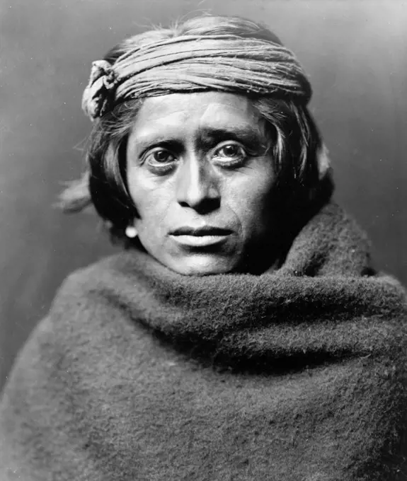 Edward S. Curtis Native American Indians - portrait of a Zuni man wearing ragged headband and blanket. 