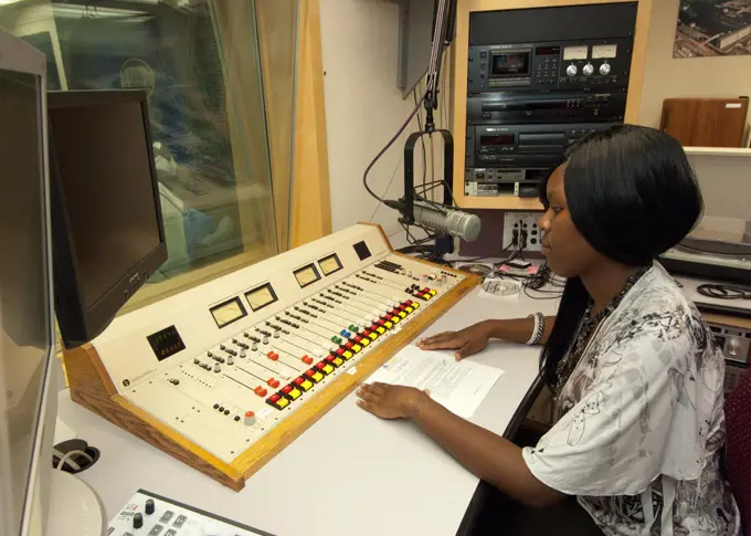 An African-American senior from Calvert High School in Calvert Texas has an opportunity to view the radio studio in the United States Department of Agriculture Creative Media and Broadcast Center from the control booth while on a Career Opportunity tour of USDA as part of a senior trip sponsored by the Farm Service Agency Ag in the Classroom” program. 