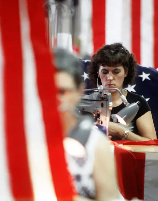 1982 - Employees of the Valley Forge Flag Company work at sewing machines to produce the United State flag.. 