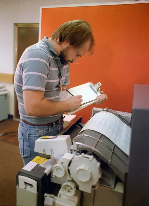 A technician monitors a computer printout while testing the electrical circuits of an MGM-118 Peacekeeper (formerly MX) intercontinental ballistic missile control guidance system.. 