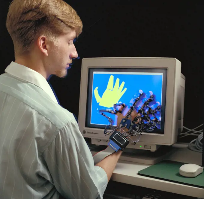 Virtual Environment Telepresence workstation, simulated Mars Exploration shows William Briggs with EXOS Dexterous interface (virtual hand). 