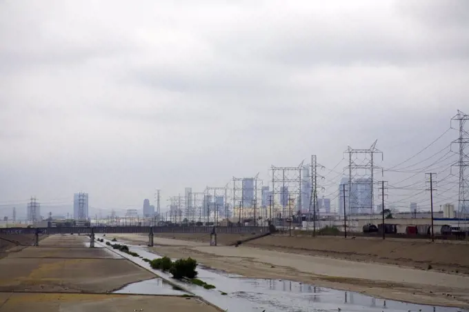 Los Angeles River. Los Angeles River and Los Angeles skyine in Background. Maywood, Los Angeles, California, USA