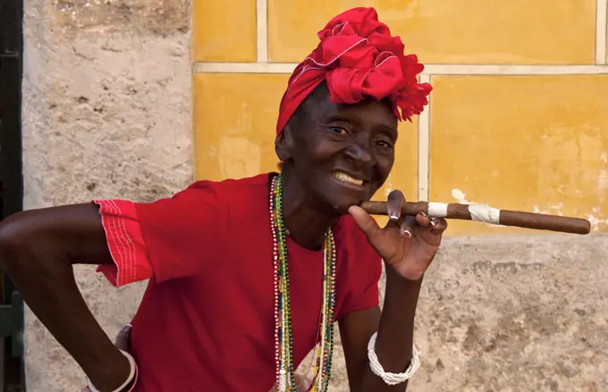 Cuban Woman In Red With Cigar In Old Havana, Cuba
