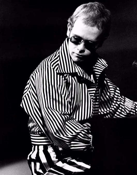 British singer, songwriter and musician Elton John (Reginald Kenneth Dwight)  playing piano. Rome, 1973.