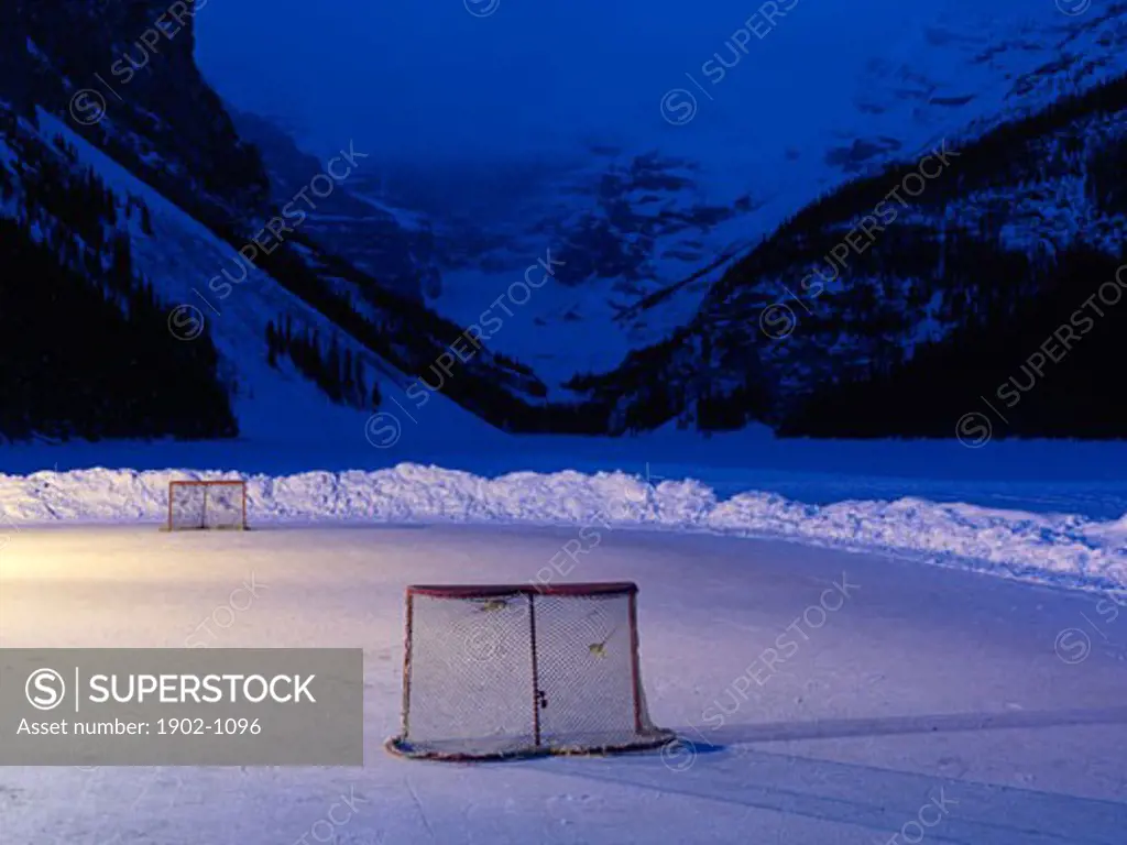 Canada Alberta Banff National Park Lake Louise ice rink with hockey nets on frozen Lake Louise at dawn