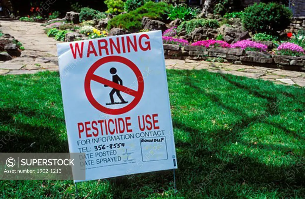 Pesticide use warning sign on lawn
