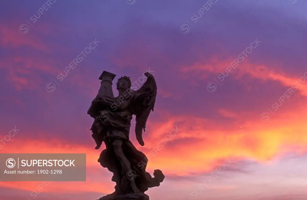 Italy Rome statue of an angel on Ponte Sant Angelo with colorful sky