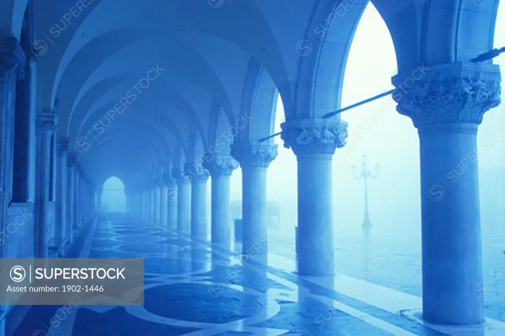 Italy Venice The Doges Palace columns and arches in the fog with blue tones