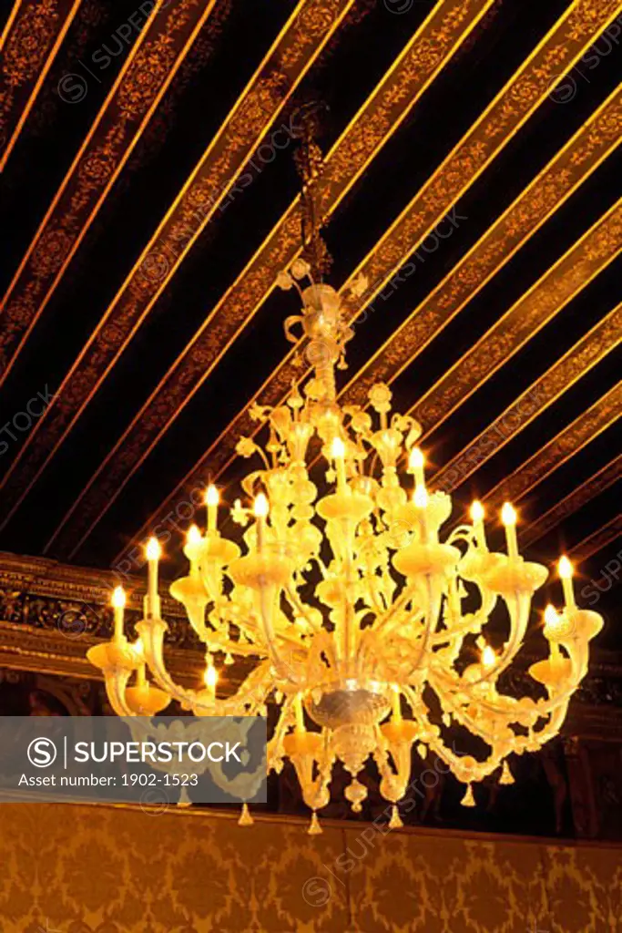 Italy Venice The Doges Palace Palazzo Ducale Venetian glass chandelier and ornately painted ceiling beams