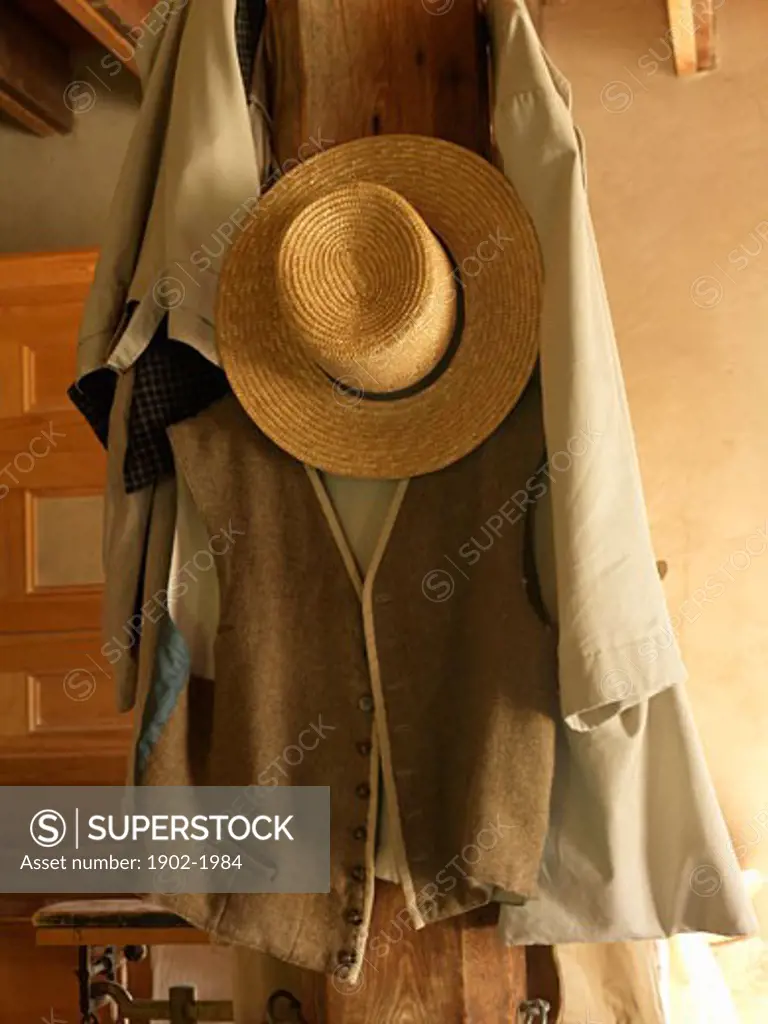 Canada Ontario Morrisburg Upper Canada Village antique straw hat and vest hanging on a wooden post