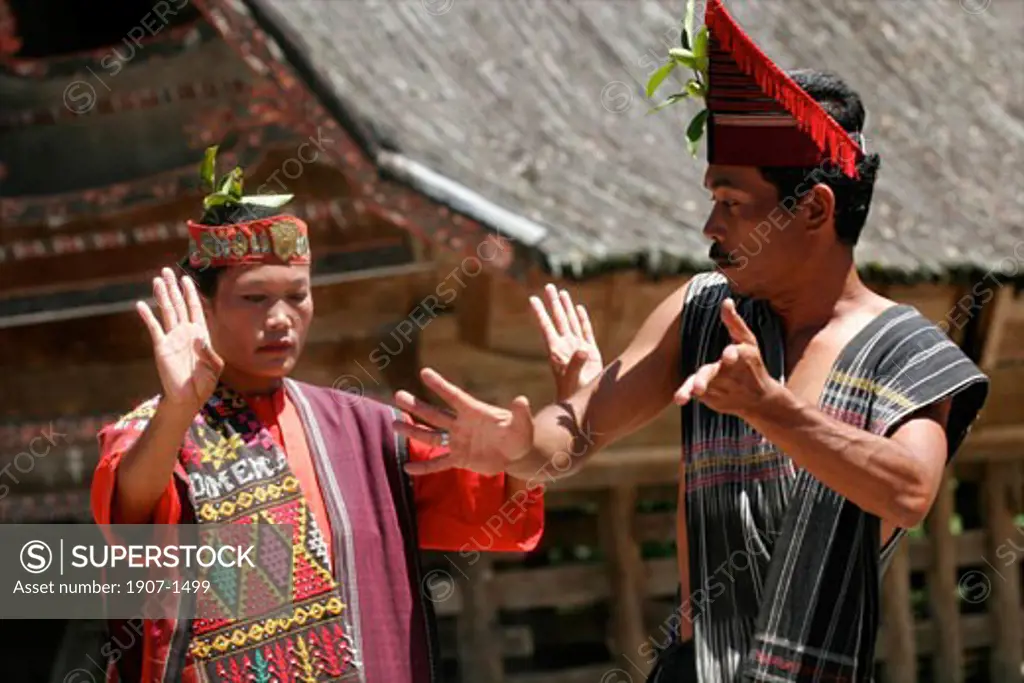 Woman and man dancing at a batak dance show in Samosir Lake Toba Sumatra Indonesia