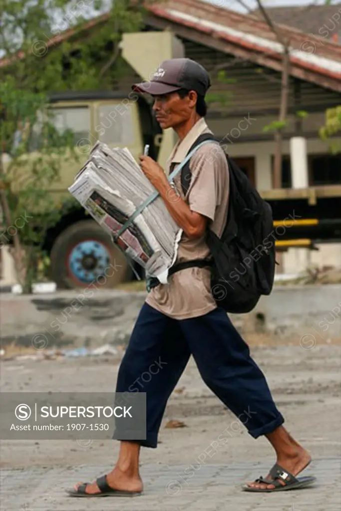 A newspapers seller in Sunda Kelapa the harbour of Jakarta Java Indonesia
