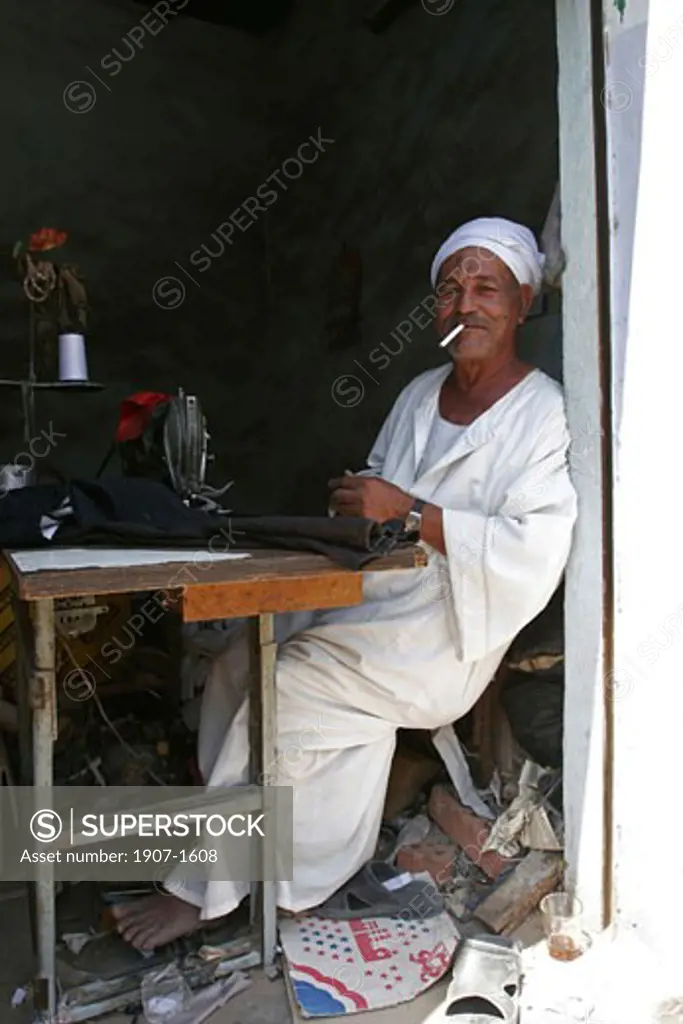 A dressmaker in the souk of Daraw big animals market Nubian Egypt