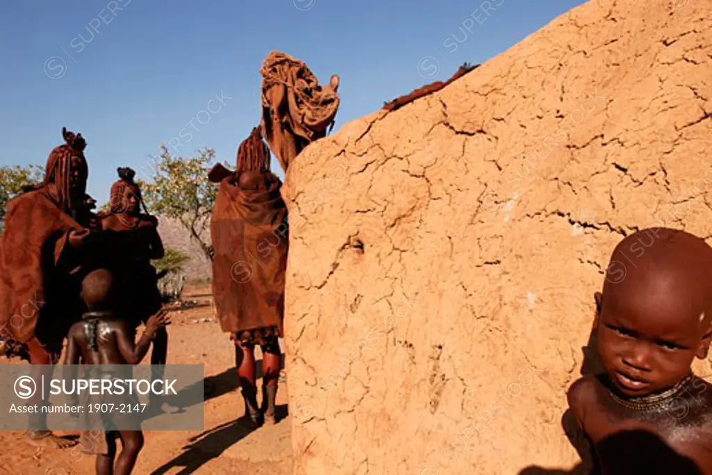 A Himba family in its village of the Kunene river  close to Epupa falls  at the boarder with Angola