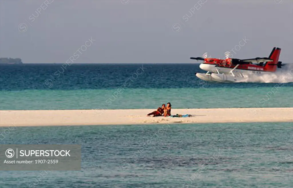 A taxi-plane landing on the sea at the White Sands hotel island Maldives