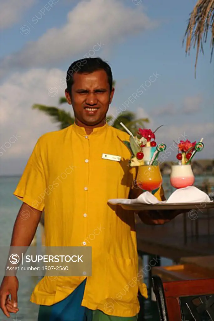 Having a cocktail at the bar at the White Sands hotel island Maldives
