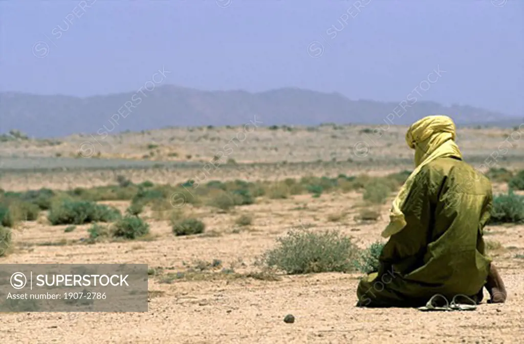 A man praying in the desert Hoggars tassilis