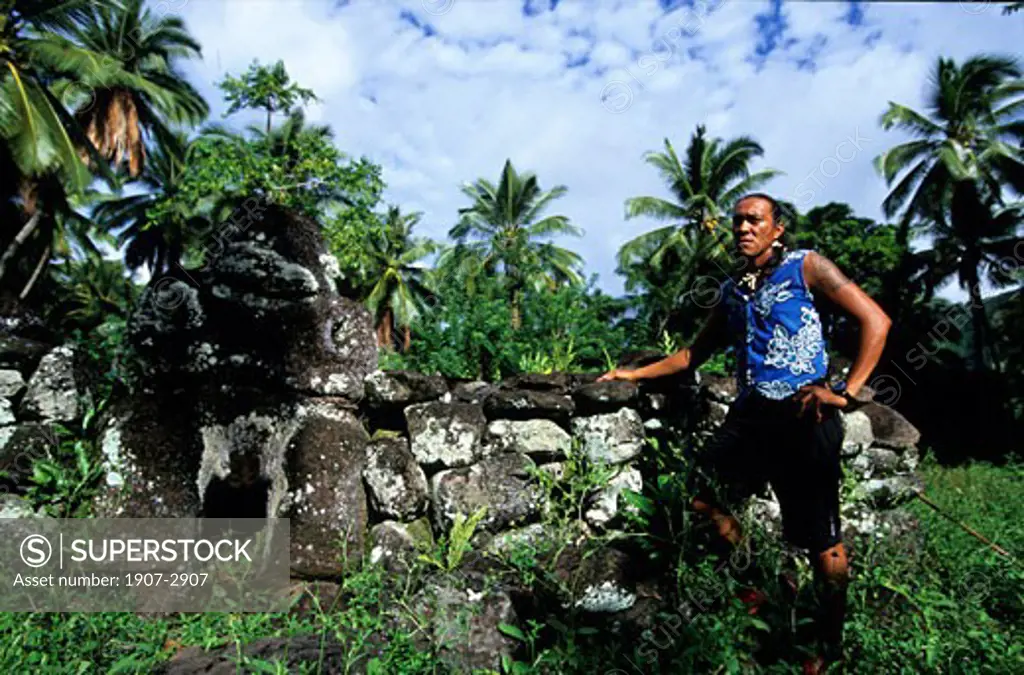 A marquisian in front of a meae ancient cult place where could have be done human sacrifices Nuku Hiva Marquises islands